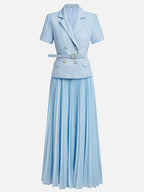 64b136-1e waistcoat and pleated skirt set featuring a tailored waistcoat and flowing pleated skirt in neutral tones.