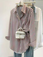 Striped pocket button shirt from 64b136-1e, featuring a casual tops design with front pocket and button closure.