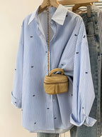 Printed striped button-up shirt from 64b136-1e, featuring a classic collar, long sleeves, and vibrant multicolor stripes.