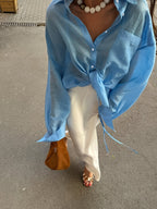 Button-front casual shirt from 64b136-1e, featuring a relaxed fit and classic collar, displayed on a hanger.