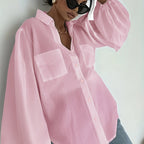 Elegant semi-sheer button-up summer top from 64b136-1e featuring a lightweight, breathable design with a classic collar and long sleeves.
