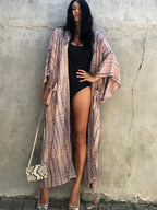 Printed loose kimono cardigan top from 64b136-1e with flowing fabric and floral print, stylish layered look, front open design.