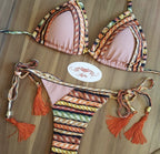 Feminine pink Brazilian bikini set swimwear with triangle top and low-rise bottoms, stylish and vibrant for beach or pool.