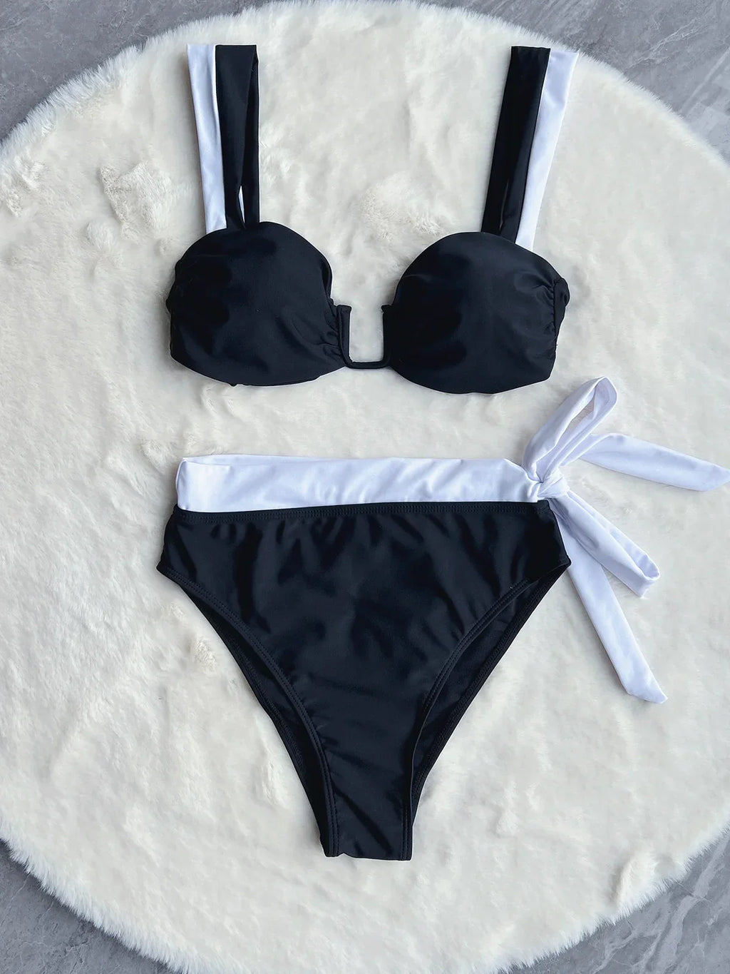Black push-up bikini swimwear by 64b136-1e, featuring a stylish 2-piece or 1-piece bathing suit with supportive design.