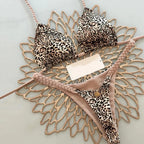 Leopard print bikini swimwear by 64b136-1e, featuring a stylish animal print design on the bikini top and bottoms.