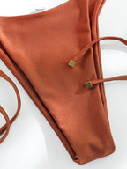 Tan brown bandeau bikini set from 64b136-1e, featuring a sleek strapless swimwear design with matching bottoms.