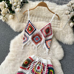 Two-piece knitted beach set with a crop top and matching shorts, featuring a stylish, textured knit fabric in neutral tones.