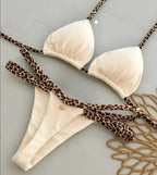 Leopard print bikini swimwear by 64b136-1e featuring a stylish, fitted top and bottom in a bold animal print design.