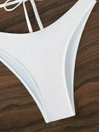 Triangle bikini set with seashell details, featuring a stylish swimwear design in vibrant colors and adjustable straps.