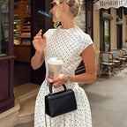 Polka Dot French Maxi Dress by 64b136-1e shows a flowing maxi dress with black polka dots on a white fabric, featuring a fitted waist.