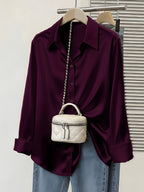 Satin commuter shirt from 64b136-1e, stylish tops with a smooth satin finish and classic collar, displayed on a hanger.