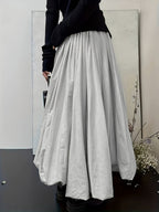 Light-colored Lantern Skirt from 64b136-1e, featuring flowing fabric and a relaxed fit, styled as a trendy bottoms piece.