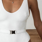 Buckled one-piece swimsuit in various colors and styles by 64b136-1e, featuring a sleek design and adjustable buckle detail.