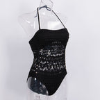 Black one-piece hollow swimsuit from 64b136-1e with cut-out design, shown on a model, ideal for stylish swimwear.
