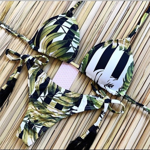 Brazilian tropical bikini swimwear with vibrant floral print, featuring a triangle top and low-rise bottoms.