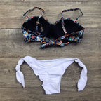 Floral print bandeau bikini from 64b136-1e swimwear featuring a strapless design and vibrant floral pattern.