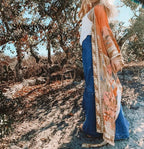 Orange floral print swimwear kimono from 64b136-1e, featuring lightweight fabric and vibrant floral design for beach or pool.