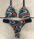 Brazilian tropical bikini swimwear by 64b136-1e featuring vibrant floral print and adjustable tie sides for a stylish beach look.