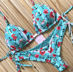 Brazilian tropical bikini swimwear by 64b136-1e featuring vibrant floral patterns and adjustable ties on a model.