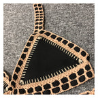 Black crochet bikini set by 64b136-1e featuring a stylish swimwear design, with the top and bottom pieces displayed on a plain background.