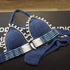 Handmade knitted bikini set by 64b136-1e, featuring a stylish swimwear design with textured knit fabric and matching top and bottom.