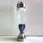 Hand-carved Natural Angel Crystal Water Bottle from 64b136-1e, showcasing intricate angel designs and clear crystal material.