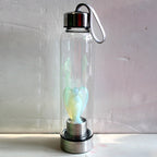 Hand-carved natural angel crystal water bottle from 64b136-1e, showcasing intricate stone craftsmanship and elegant design.
