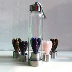 Hand-carved natural angel crystal water bottle by 64b136-1e, showcasing intricate details and smooth, polished crystal surface.