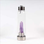 Clear natural crystal water bottles with black caps, showcasing their transparent design and smooth, rounded shapes.