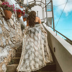 Black lace maxi dress cardigan from 64b136-1e, featuring flowing fabric and intricate lace details, displayed on a hanger.