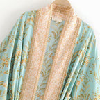 Boho Chic turquoise kimono outerwear with flowing sleeves and intricate patterns, stylish and lightweight for casual wear.