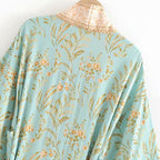 Boho chic turquoise kimono outerwear featuring flowing fabric and bohemian style, perfect for casual and layered looks.